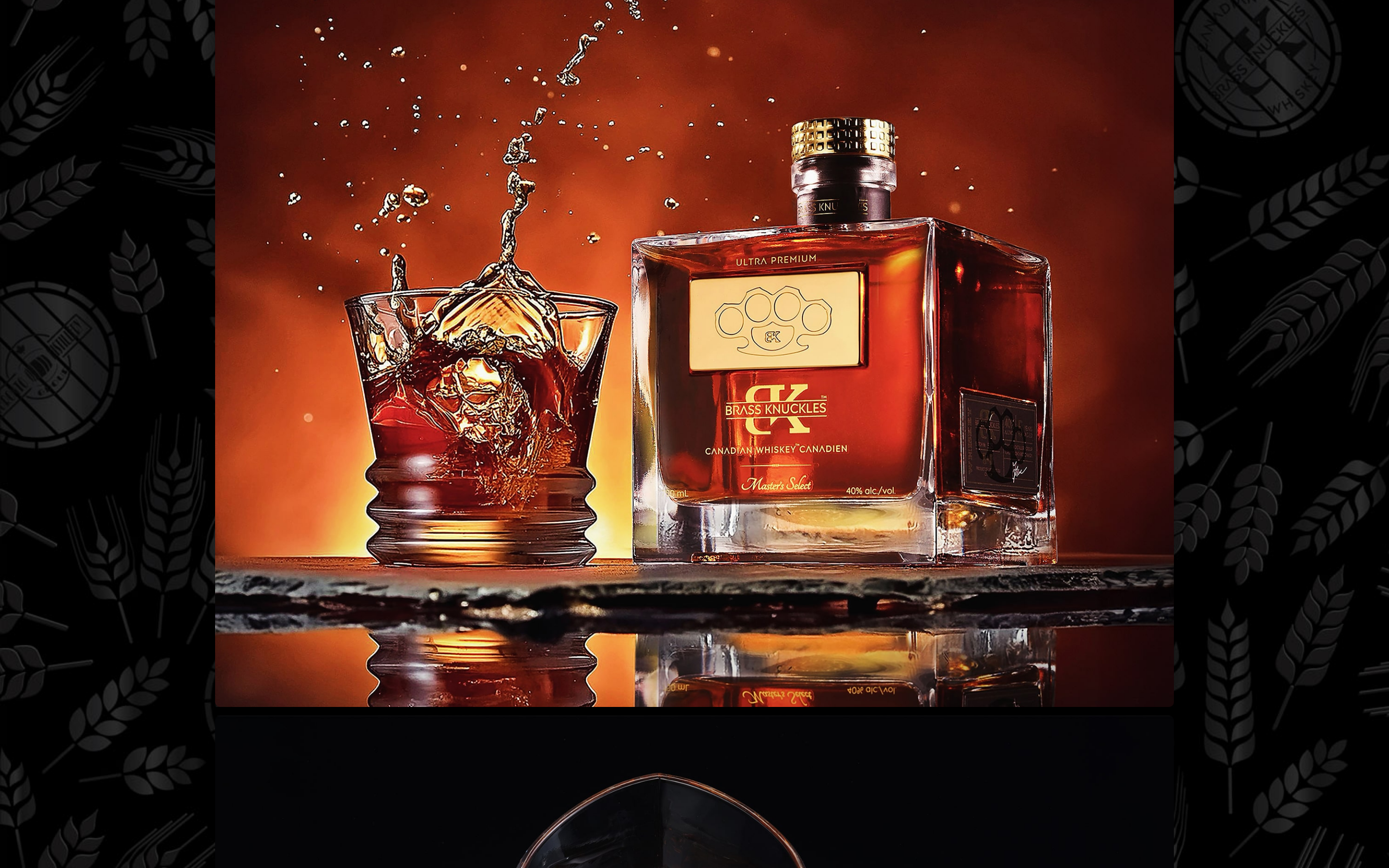Whiskey bottle beside a splashing glass of whiskey on ice on a bar top